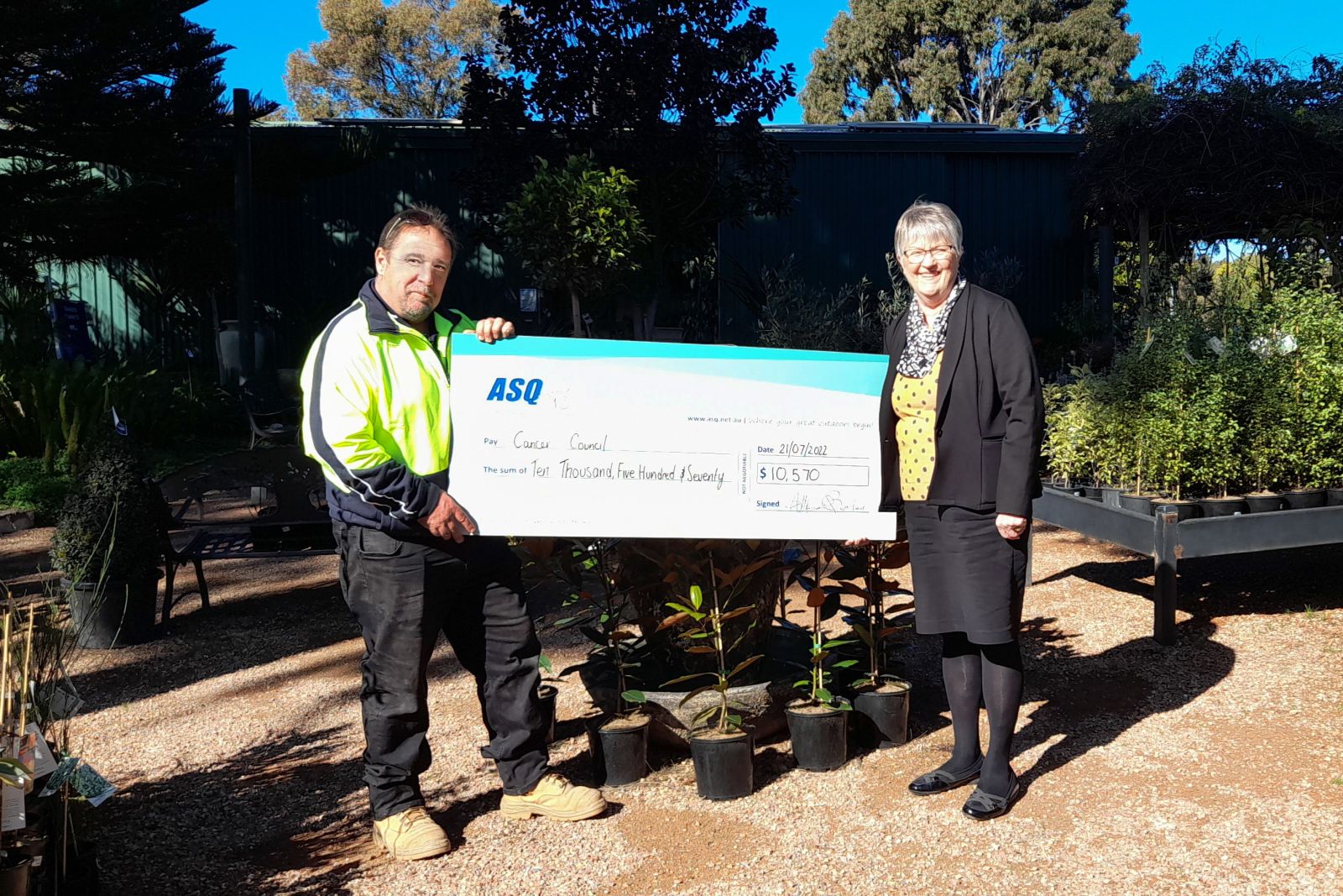 Terry, ASQ Garden & Landscape manager presenting cheque to the Cancer Council