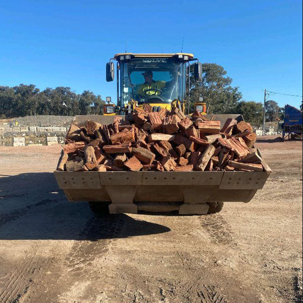 Bucket of firewood pictured in bucket of Scotty's loader at ASQ Garden & Landscape Eaglehawk